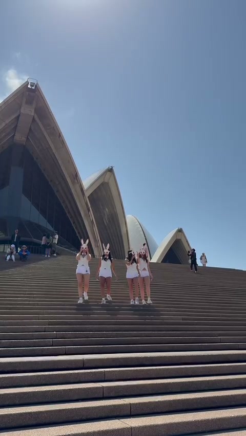Performers descending Opera House steps in bunny masks